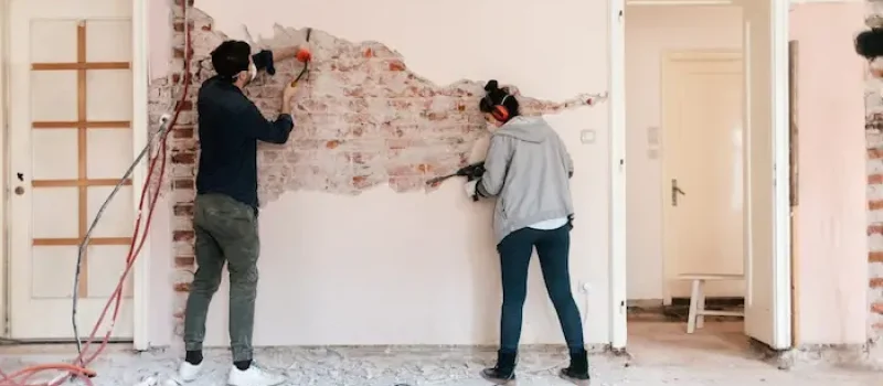 دو مرد در حال کندن روکش گچ دیوار 8547
